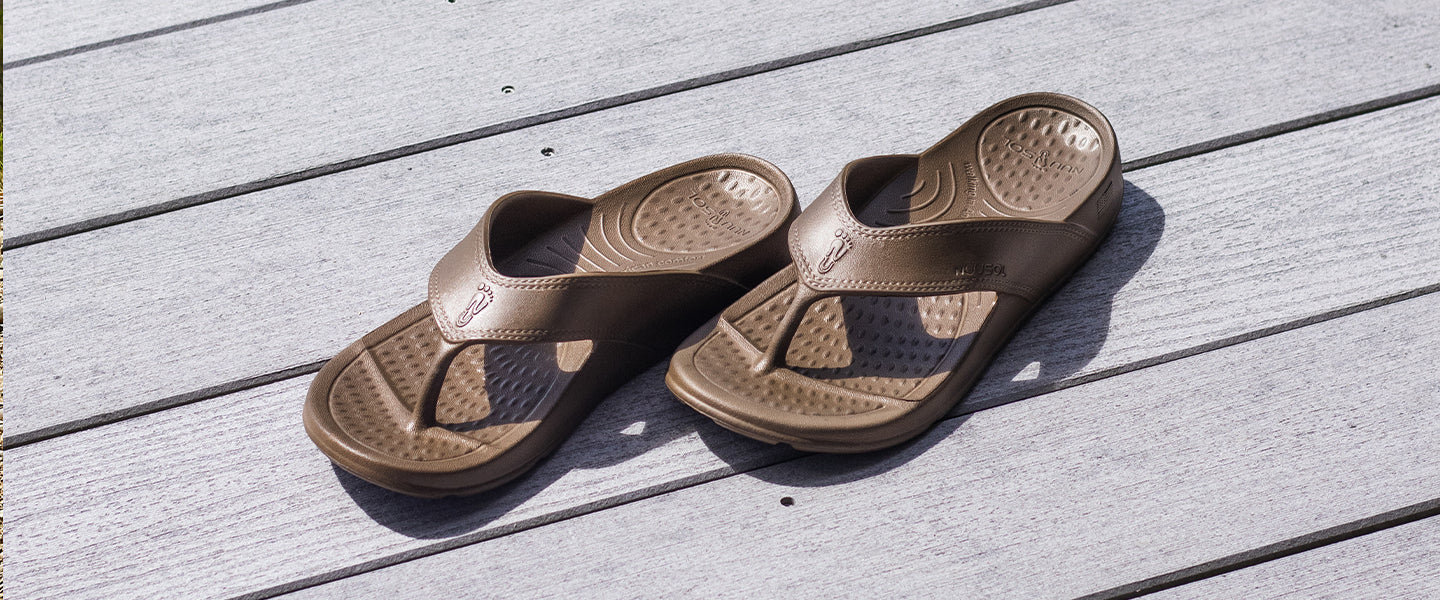 pair of nuusol cascade flip flops on dock with sunshine casting a sandal shadow